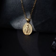 Virgin Mary charm necklace for mama, Mother Mary pendant necklace in 10K gold, Christian necklace for mother's day gift Introducing our stunning Virgin Mary pendant! This exquisite piece of jewelry is a timeless symbol of faith and spirituality. Crafted with meticulous attention to detail, the pendant features a beautifully sculpted depiction of the iconic Virgin Mary. The delicate curves and intricate textures of this pendant make it a true work of art. Made with high-quality materials, this pe Spiritual Charms Necklace For Mother's Day, Gold Medallion Necklace With Charms As Gift, Dainty Oval Charm Necklaces, Dainty Oval Charms Necklaces, Gold-plated Oval Pendant Jewelry With Charms, Gold Oval Pendant Jewelry With Charms, Dainty Oval Necklaces With Charms, Yellow Gold Oval Jewelry For Personalized Gift, Spiritual Pendant Jewelry For Mother's Day