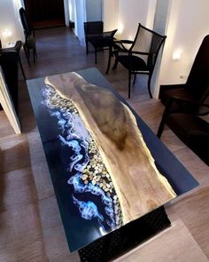 a table that is made out of wood and glass with an ocean scene on it