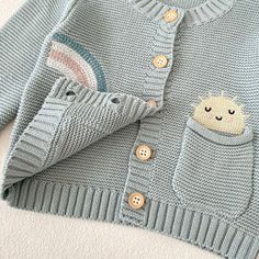 100% Knit Cotton: An eco-friendly, breathable, and hypoallergenic fabric. Care Instructions: Machine wash on a low or delicate setting. Tumble dry on a gentle or low heat. Ideal Gift: Suitable for birthdays, baby showers, holidays, or making any day memorable for the little one in your life. Light Blue Knitted Cotton Sweater, Cute Blue Knit Sweater, Cute Light Blue Long Sleeve Sweater, Cute Cotton Soft Knit Sweater, Playful Knitted Cotton Cardigan, Playful Cotton Knitted Cardigan, Spring Cotton Cardigan For Playtime, Cute Spring Cardigan For Playtime, Soft Knit Long Sleeve Sweater For Playtime