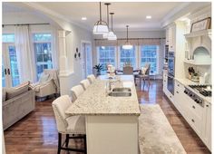 a large kitchen with an island in the middle and lots of counter space on one side