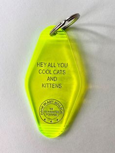 a yellow keychain with the words hey all you cool cats and kittens written on it