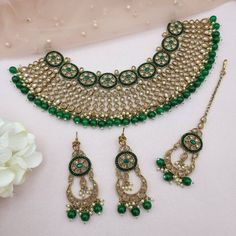 'SANAM' Bridal Diamond Polki necklace set  This necklace is a unique blend of bold and classy! Made with fine Diamond Polki on the highest quality brass as the base metal. Delicate necklace accented with emerald green color beads. This necklace comes with matching earrings and Maang tikka. Necklace witdh 6cmm Earrings and tikka L6cm approx Step into the world of high fashion and luxury with this statement piece. Kundan Necklaces With Matching Earrings For Festivals, Bollywood Festive Necklaces With Matching Earrings, Festive Kundan Bridal Necklace With Matching Earrings, Bollywood Chandbali Necklace With Matching Earrings, Green Jewelry Sets With Stone Work, Festive Jewelry Sets With Stone Work, Green Jewelry With Tilla For Navratri, Green Tilla Jewelry For Navratri, Green Heavy Necklace For Navratri