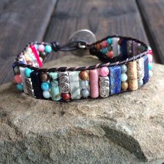 This multi color beaded bracelet for women is stunning and unique. This single wrap bracelet would compliment and outfit you want to wear it with. This bracelet would be a beautiful meaningful gift for your mother on Mother's Day. It will be a gift she can enjoy every day. This leather beaded bracelet is made with a variety of gemstone beads in various sizes and colors. Please choose the size you would like at check out. Adjustable Multicolor Artisan Wrap Bracelet, Spiritual Multicolor Adjustable Wrap Bracelet, Beaded Wrap Bracelet For Gift, Adjustable Natural Stones Wrap Bracelet, Artisan Adjustable Wrap Bracelet For Gift, Multicolor Hand Wrapped Leather Bracelet As Gift, Artisan Adjustable Wrap Bracelet Gift, Adjustable Leather Bracelet With Round Beads As Gift, Adjustable Colorful Beads Wrap Bracelet