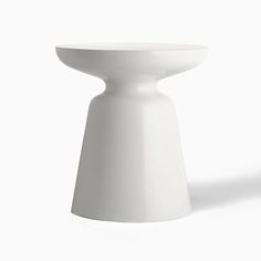 a white table sitting on top of a white floor