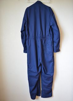 "Unused Swiss army blue overalls for technician with tags on sleeve. Good military uniform of high quality materials and in perfect condition. Suitable for both fashionable upgrades or for work wear). Coton 35% Polyester 65%. Please see detailed measurements to ensure the desired fit. If you have any questions regarding the size or state of a particular combination, please contact. Sign on a sleeve can be removed at the buyer's request. CONDITION: unused warehouse, detail in the photo. MEASUREME Fitted Blue Utility Overalls, Blue Workwear Overalls, Vintage Blue Overalls For Workwear, Workwear Overalls With Button-up Closure, Vintage Blue Shortalls, Jumpsuit Vintage, Army Fatigue, Blue Overalls, Coverall Jumpsuit