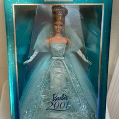 a barbie doll in a blue dress and tiara