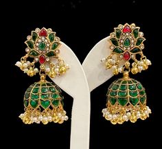 Royal Jadau Kundan Jhumka in matte gold plating with Charming pearl dangling at the base to add the beauty. This Jhumka is real look alike.  *Best quality and highest craftsmanship. *Earring closure: Screw back *Length : approx 2.25 inches You're going to love this Earrings and our customer service! Please note: Color and shading may slightly* vary from the actual product due to lighting conditions and screen settings. Care instructions: Please keep your Jewelry away from moisture, direct perfum Green Tilla Jhumkas For Ceremonial Occasions, Ceremonial Green Jhumkas With Tilla Detailing, Ceremonial Green Jhumkas With Latkans, Ceremonial Green Tilla Jhumkas, Kundan Jhumka, Jewelry Kundan, Box Pouch, Safe Box, South Indian Jewelry