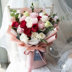 a bouquet of flowers sitting on top of a chair