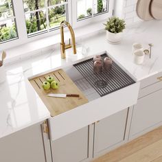 an image of a kitchen setting with apples on the cutting board in the center sink