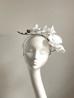 White orchid crown White orchid crown is made from white silk covered headband on which attached white orchid flowers and white netting in the front.  It's simple and elegant. A fascinator will be an amazing accessory to compliment your outfit. The crown fascinator will fit the average head size.  You can wear this lovely fascinator for a Wedding, Royal Ascot Derby races, or any other special occasion like Ladies day or a Garden party. Enjoy your special day with this beautiful headpiece! White Spring Wedding Headband, White Spring Headpiece With Pinched Crown, White Pinched Crown Headpiece For Spring, Adjustable White Fascinator With Pinched Crown, White Headpiece With Pinched Crown For Spring, White Mini Hat With Pinched Crown For Spring, Elegant White Flower Headband, Elegant White Flower-shaped Mini Hats, Elegant White Flower Mini Hat