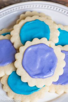 some cookies with blue icing on a white plate