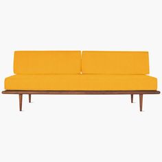 a yellow couch sitting on top of a wooden frame