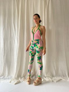 Vintage 80s KENZO Floral Woolen Trousers All-over floral print Green central button fastening at the waist, zip closure Inner waistband 'KENZO PARIS' logo detailing Very flattering, fitted style slightly looser to the ankle On myself these sit slightly high waisted and graze my ankles 100% wool with a stretch, the fabric is light Due to the age of this item there is some wear and tear, at the time of purchase over ten years ago there were two small holes in the fabric which I meticulously stitched up, now barely noticeable. Other than that for the age these trousers are in very good condition. The label states FR38 which equates to a UK12. However I am roughly a UK8 with a bum on the larger side and these fit me like a glove due to the stretch, I believe they would work well for a UK6/8 an Retro Printed Bottoms For Spring, Vintage Printed Bottoms For Spring, Vintage Fitted Printed Bottoms, Retro Stretch Bottoms With Floral Print, Retro Pink Floral Print Bottoms, Retro Pink Bottoms With Floral Print, Vintage Pink Floral Print Bottoms, Retro Fitted Floral Print Bottoms, Fitted Green Floral Print Bottoms