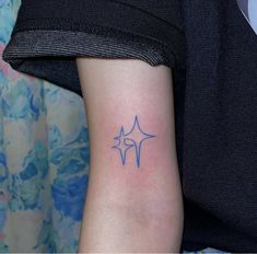 a woman's arm with a tattoo on it that has the shape of a star