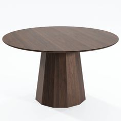 a round wooden table sitting on top of a white floor