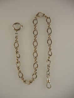 This is a yellow gold filled chain which measures 310mm from the dog clip to the bolt ring. The chain is made up of a single length of oval links decorated with fine engraving interspersed with two oval links. The chain is in 95% mint condition Antique Jewelry With Oval Link Curb Chain, Antique Oval Link Gold Chain Jewelry, Vintage 14k Gold Chain Link Bracelet, Victorian Link Jewelry With Curb Chain, Antique Oval Link Chain Jewelry, Classic Engraved Oval Link Chain Bracelet, Antique Gold Chain Jewelry, Victorian Gold Chain Jewelry With Oval Links, Victorian Jewelry With Oval Link Gold Chain