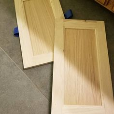 two unfinished wooden doors laying on the floor