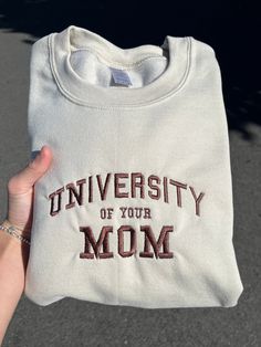 University of your MOM Sweatshirt! These sweatshirts and more are hand-made Each article made is locally crafted with heavy input from you! The sweatshirts and color of stitching can be picked according to your desires, and our advanced machine makes it possible to do almost any possible color combination. Kindly feel free to contact us at any time about any questions you might have!! Embroidered Clothes Ideas, University Of Your Mom, Sweatshirts Ideas, Cute Crewneck Sweatshirt, Sweatshirts Cute, Embroidery Hoodie, Cute Shirt Designs, Embroidered Crewneck, Sweatshirt Crewneck