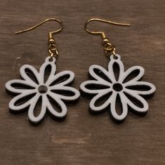 White Daisy drop earrings, minimalist floral dangle earrings, laser cut from 3mm bass wood. Earrings are sealed with polyurethane. Flower earrings are approximately 1.25 inches with a .5 inch drop. Available with stainless steel hardware in silver or gold. Earrings are very light, you will forget that you have them on. Thank you for visiting Sprouting Expressions, please see my other listings and like my shop for updates on new products and sales! I hope you love my handmade items as much as I l White Laser-cut Jewelry For Gifts, White Laser Cut Earrings As A Gift, White Laser Cut Earrings For Gift, Laser Cut Wood Earrings, Light Weight Jewelry, Daisy Earrings, White Daisy, Earrings Minimalist, Laser Cut Wood