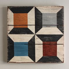 a wooden block with an abstract design painted on it