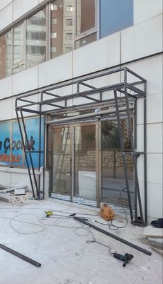 an empty building that is being renovated with construction equipment on the ground in front of it