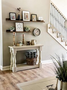 a living room filled with furniture and pictures on the wall