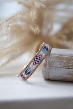 ↠ DESCRIPTION OF THE JEWELRY ↞ This Kwanita wrap bracelet is a tribute to the richness of Native American culture. Each Miyuki bead is carefully selected for its quality and consistency, creating designs inspired by Native American arts and spirituality. The colors of blue, red and white evoke sky, earth and purity, while the patterns tell ancient stories. The result is a piece of jewelry that celebrates the timeless beauty of Native American culture. ↠ SPIRITUAL MEANING ↞ The colors and pattern Adjustable Woven Wrap Bracelet As Gift, Adjustable Woven Wrap Bracelet Gift, White Bohemian Woven Jewelry, Bohemian White Woven Jewelry, Artisan Woven Jewelry As A Gift, Artisan Woven Jewelry Gift, White Hand-wrapped Friendship Bracelets For Festivals, White Hand Wrapped Friendship Bracelets For Festivals, White Woven Bracelet Jewelry