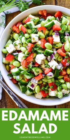 a salad with tomatoes, cucumbers and feta cheese in a white bowl