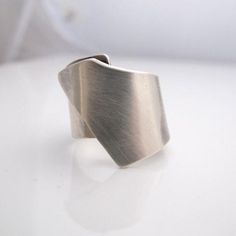 Silver wide band Silver Ring for woman, modern ring Simplicity is handmade and designed by me. It is simple but significant.. Ring is made of 0.9 mm (0.0276 inch) tick Sterling Silver. It is 2,2 cm ( 0.86  inches) high in front ( the highest side of the ring)  and 1.1 cm (0.43 inches) on the back side. Brushed finish. Let me know your size during check out. Please keep in mind that each one is unique so yours won't be identical to the photo but very similar. All items are nicely packed and ready to be given as a gift.  I use US ring size chart,  but for my EU based costumers please contact me for your ring size , or just let me know your  German or UK or French  ring size during checkout. Ring sizes can be displayed only in one ring  size chart unfortunately. I need 6 working  days  for fa Modern Sterling Silver Wide Band Ring With Open Design, Modern Sterling Silver Wide Band Ring With Open Band, Modern Sterling Silver Wide Band Ring With Open Shape, Handmade Modern Wide Band Ring, Modern Silver Wide Band Ring For Everyday Wear, Modern Silver Rings With Brushed Finish, Modern Ring, Ring Sizes, One Ring