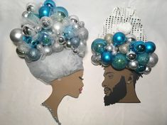 two paper cutouts of people with christmas ornaments on their heads, one in the shape of a woman's head