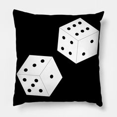 two white dices sitting on top of a black pillow