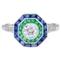 For Sale on 1stDibs - An incredibly stylish Art Deco target ring, set with a double halo clusters of gemstones – blue sapphire and emerald around a central old cut diamond. Antique Emerald Engagement Ring, Target Ring, Double Halo Ring, Emerald Ring Engagement Diamond, Vintage Engagement Rings Sapphire, Vintage Art Deco Rings, Platinum Diamond Engagement Rings, Vintage Sapphire, Diamond Anniversary Rings