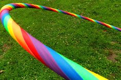 a rainbow colored tube laying in the grass