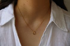 This dainty necklace is beautiful in its simplicity. D E T A I L S🌙 *It features a Korean-made gold plated hammered moon charm measuring 10mm x 8.5mm. *And a small crystal pendant. *It is suspended from a delicate 14k non tarnish stainless steel chain. *Length: Choose the length you prefer from the drop down menu. Use the length chart as a reference.  C A R E * T I P :  To keep your necklace in good condition please avoid contact with water, perfume and body lotion and remove when exercising or sleeping to preserve the beauty of the gold plated moon charm. Also store carefully as thin chains can easily tangle.   P A C K A G I N G All our products are gift ready. T E R M S* O F* S A L E S & F A Q https://etsy.me/2PuWBv6 F O L L O W Instagram: @Allaboutevecreations and  Facebook: www.facebo Moon Charm, Moon Necklace, Dainty Necklace, Stainless Steel Chain, Crystal Pendant, Charm Necklace, Gifts For Kids, Gold Necklace, Jewelry Necklaces