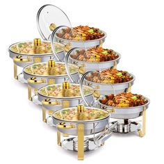 a set of six serving dishes with gold trimmings on each side and one bowl full of food in the middle