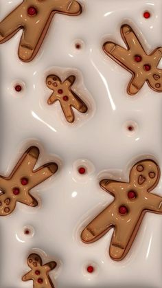 there are many cookies shaped like people on the plate together, and one has been cut out to look like gingerbreads