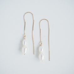 A combination of one small and one large Freshwater Pearls hang on elegant threader style earrings. A minimalist design with a modern edge. A go-to bridal earring choice.    Our Double Pearl Threaders have a gorgeous subtle movement, making them a focal point to any outfit.    DETAILS ~ pearls approximately measure: small pearl 6x4mm, large pearl 7x5mm  ~ all pearls vary in shape and colour. We can not guarantee that any two will be alike or exactly like the pictures shown. Pearls are very delicate, take care of these babies.  ~ total drop length from ear lobe is approx 4.5cm ~ available in Sterling Silver and 9ct Yellow Gold ~ is your order a gift? a handwritten note can be included to your order for that personal touch. let me know in the checkout upon ordering and I'll make sure to add Minimalist Adjustable Earrings For Formal Occasions, Minimalist Adjustable Formal Earrings, Minimalist Formal Earrings, Classic 14k Gold Threader Earrings, Minimalist Gold Bridal Earrings In Sterling Silver, Minimalist Gold Sterling Silver Bridal Earrings, Wedding 14k Gold Linear Earrings With Ear Wire, Adjustable Teardrop Pearl Earrings In Minimalist Style, Delicate 14k Gold Linear Earrings For Wedding