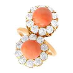 A stunning antique 6.06 carat coral and 2.86 carat diamond, 18 karat rose gold dress ring; part of our diverse antique jewelry and estate jewelry collections. This stunning, fine and impressive antique coral ring has been crafted in 18k rose gold. The pierced decorated twist style setting displays two bead cut corals, totalling 6.06Ct. Each coral is each encircled by ten claw set Old European cut diamonds, totalling 2.86Cts. The elevated ring shoulders integrate with the main setting and blend s Antique Gemstone Rings, Diamond Dress Ring, Rose Gold Dress, Twist Style, Gold Cocktail Ring, Coral Ring, Gold Cocktail, Dress Rings, European Cut Diamonds