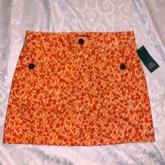 Orange Floral Skirt With Belt, Loops Button, And Zipper Closure, Has Two Front Pockets With Button Closure. New With Tags. Spring Cotton Mini Skirt With Buttons, Summer Mini Skirt With Buttons, Spring Button-up Lined Skirt, Fitted Spring Skort With Button Closure, Spring Mini Skirt With Buttons, Spring Cotton Skort With Buttons, Cotton Skort With Buttons For Spring, Spring Fitted Button-up Mini Skirt, Spring Mini Length Skort With Buttons