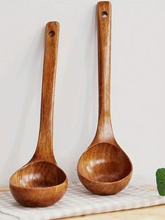 two wooden spoons sitting next to each other