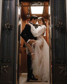 a bride and groom kissing in an elevator