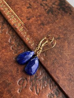 "Lapis Lazuli Earrings, Solid 14k Gold, Navy Blue Teardrop Earrings, Real 14k Gold, Simple Royal Blue Earrings, Yellow Gold Gift for Wife These earrings are made with authentic Solid 14k Gold, guarantied to never tarnish or give an allergic reaction. Ideal for an anniversary gift, or that \"something blue\" for a bride, these lapis earrings are a forever piece of jewelry that can remain in your family for generations to come. - Stone: Lapis Lazuli - Birthstone Month: September - Stone Size: 14 m Classic Sapphire Dangle Jewelry, Blue Briolette Teardrop Earrings For Gift, Blue Pear-shaped Earrings For Gift, 14k Gold Sapphire Jewelry With Matching Earrings, Sapphire Teardrop Gemstone Earrings, Fine Jewelry Teardrop Dangle Earrings As Gift, Blue 14k Gold Dangle Jewelry, Blue 14k Gold Drop Earrings, Nickel-free Pear-shaped Earrings For Gifts