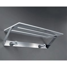 a metal shelf mounted to the wall with two hooks on each side and one hook in the middle