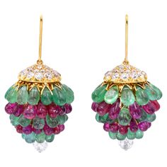 Art Deco Ruby, Emerald, and Diamond Chandelier Earrings. 18k yellow gold cap of the earrings is set with old european cut diamonds. Suspended from underneath are cabochon emeralds and rubies. Accented with a diamond ball on the bottom. Measuring approximately 50mm x 30mm Weight: 45 grams Ear Tops, Grandmother Jewelry, Diamond Chandelier Earrings, Diamond Chandelier, Gold Cap, Lotus Jewelry, Ear Chain, Antique Jewellery Designs, Customizable Jewelry