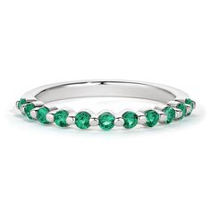 a white gold band with green stones