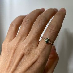 a woman's hand with a ring on it