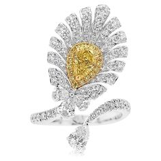 A one-of-a-kind Cocktail ring with a feather-like appearance dazzling with mesmerizing Yellow diamonds and white diamonds - Centre Diamond, GIA Certified Pear-shape Yellow Diamond 0.50 carat - Round Brilliant Cut Yellow Diamonds total 0.09 carat - Pear-shape White Diamonds total 0.50 carats - Round Brilliant Cut White Diamonds total 0.77 carat - Made of 18K White and Yellow Gold - Ring Size US6 (can be sized upon request) Yellow diamond primarily originates from South Africa. Approximately 1 out 16,500 carats that are mined are yellow diamond which also makes them rare. HYT Jewelry is a privately owned company headquartered in Hong Kong, with branches in Tokyo, New York, and Bangkok. The company specializes in fine jewelry. It is renowned for an exceptional range of Fancy Color Diamonds an Dig Jewelry, Yellow Diamonds, Colombian Emeralds, Fancy Color Diamonds, Timeless Jewelry, Yellow Diamond, Exquisite Jewelry, High Jewelry, White Diamonds