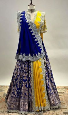 a yellow and blue lehenga is displayed on a mannequin