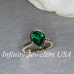 "The ring pictured is lab created emerald #7072 Rose Gold is available upon request as a custom order and is a final sale (non refundable, non returnable, non exchangeable). -Approximate total carat weight: approx. 2.10ctw diamond equivalent -Center Stone Size: 10x7mm - approx. 2.10ct diamond equivalent -Center Stone Shape: pear shape -Gem Type: lab created emerald -Stone Clarity: VS2 -Stone Color: Green -Moh's Scale: 8.5 hardness -Metal Type and Purity: 14k yellow gold -Setting: bezel set -Stoc Classic Pear-shaped Green Ring, Classic Green Pear-shaped Ring, 14k Gold Gia Certified Emerald Ring For May Birthstone, Gia Certified 14k Gold Emerald Ring For May Birthstone, Pear-shaped Emerald Jewelry In Yellow Gold, Classic Teardrop Emerald Jewelry, Gia Certified Pear-shaped Green Emerald Ring, Classic Pear-shaped Emerald Jewelry, Classic Teardrop Emerald Ring For Formal Occasions