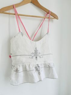 Reworked vintage embroidered linen cami beach festival top. Handmade one off top size 8-10uk White Embroidered Cami Tank Top, Floral Embroidery Spaghetti Strap Tops For Beach, Floral Embroidered Spaghetti Strap Tops For Beach, Floral Embroidery Spaghetti Straps Beach Tops, Summer Embroidered Camisole Tank Top, Embroidered Camisole Tank Top For Summer, Fitted Embroidered Tank Top For Beach, White Tie-strap Camisole For Summer, White Linen Cami Tank Top